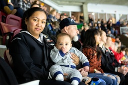 Navy Recruiter readies to conduct oath of enlistment ceremony during Idaho Steelheads match