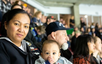 Navy Recruiter readies to conduct oath of enlistment ceremony during Idaho Steelheads match