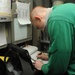 U.S. Navy Sailor Inspects Landing Gear