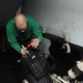 U.S. Navy Sailor Inspects Landing Gear