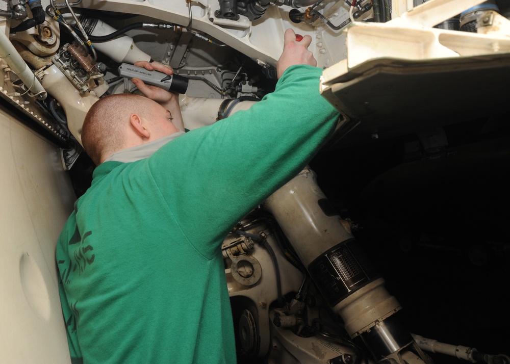 U.S. Navy Sailor Inspects Landing Gear