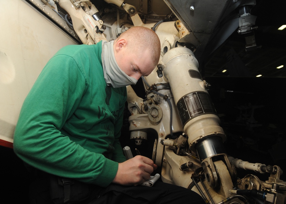 U.S. Navy Sailor Inspects Landing Gear