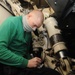 U.S. Navy Sailor Inspects Landing Gear