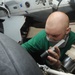 U.S. Navy Sailor Inspects Landing Gear