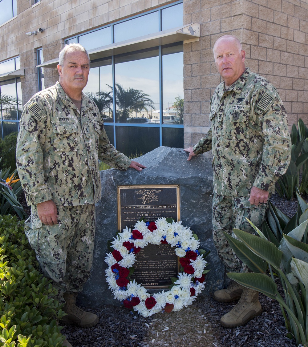 Rear Adm. Collin Green, Commander, Naval Special Warfare Command, left, and Naval Special Warfare Force Master Chief (SEAL) Bill King lay a wreath on the Extortion 17 Memorial in observance of the 9th anniversary of Extortion 17.