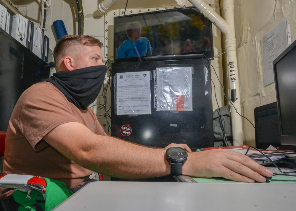 Aviation Maintenance Administrationman Works On Support Equipment Records Aboard Aircraft Carrier USS Nimitz CVN 68