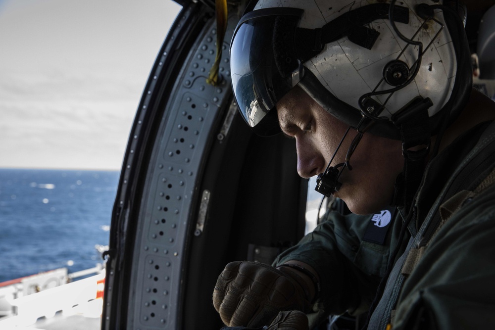 USS Makin Island and HSC 23 work together in a straits transit drill.