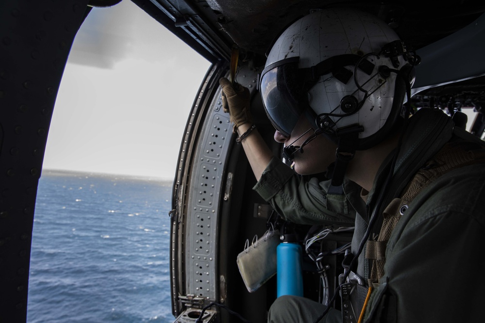 USS Makin Island and HSC 23 work together in a straits transit drill.