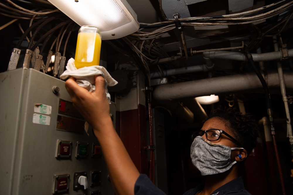 USS Princeton Sailor inspects an oil sample