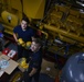 Coast Guard crew members perform pre-patrol repairs and maintenance