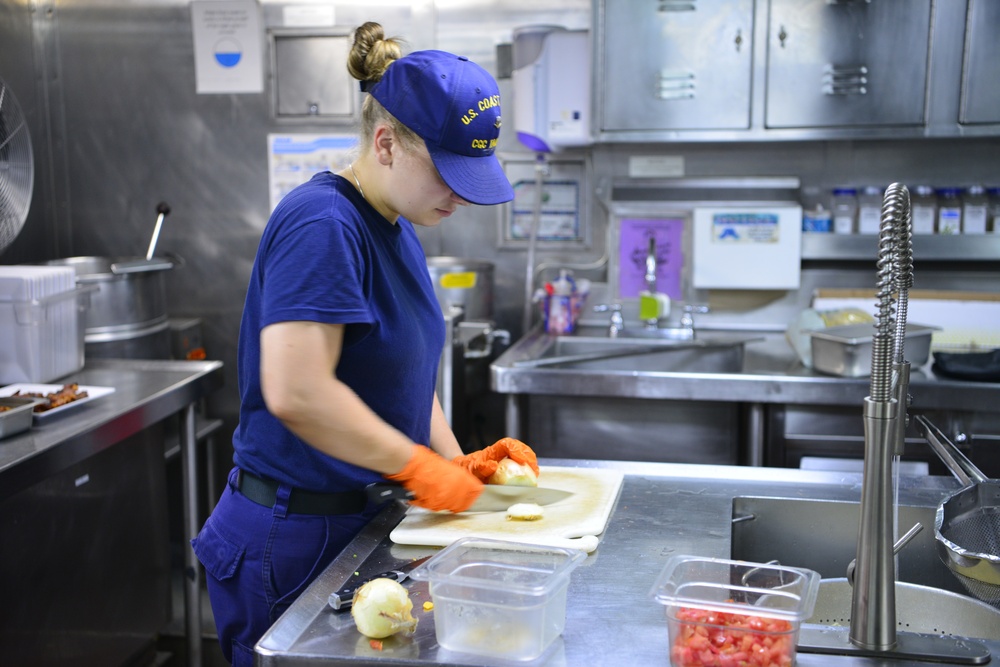 Coast Guard culinary specialist prepares food for crew members