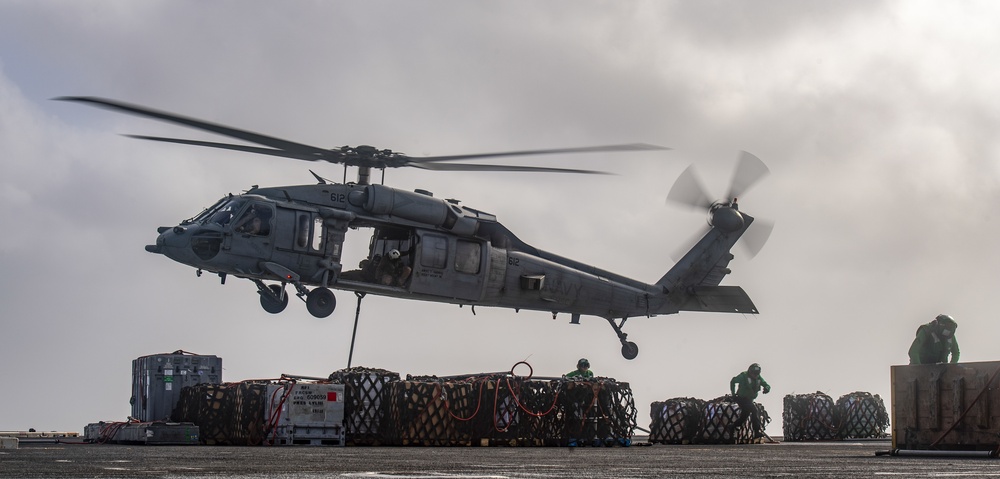 An MH-60S Sea Hawk Helicopter Transports Cargo To Nimitz