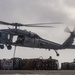 An MH-60S Sea Hawk Helicopter Transports Cargo To Nimitz