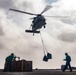 An MH-60S Sea Hawk Helicopter Transports Cargo To Nimitz