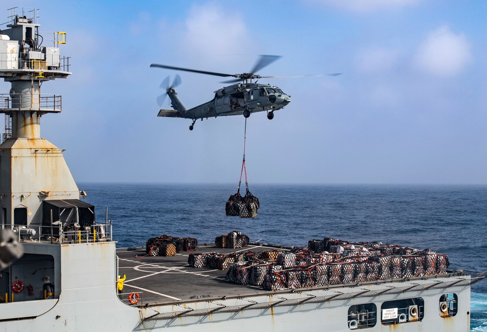 An MH-60S Sea Hawk Helicopter Transports Cargo To Nimitz