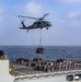 An MH-60S Sea Hawk Helicopter Transports Cargo To Nimitz