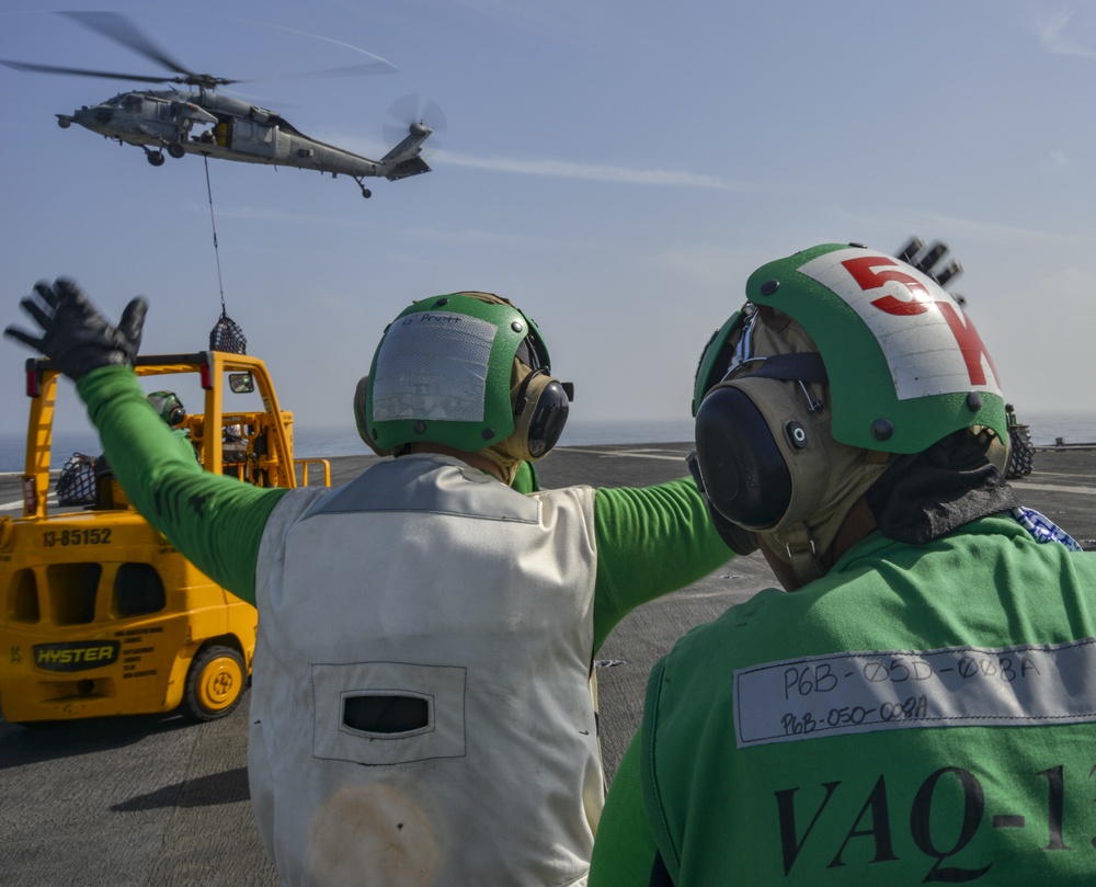 Logistics Specialist Orchestrates Cargo Movement During Vertical Replenishment-At-Sea On Flight Deck Aboard Aircraft Carrier USS Nimitz CVN 68