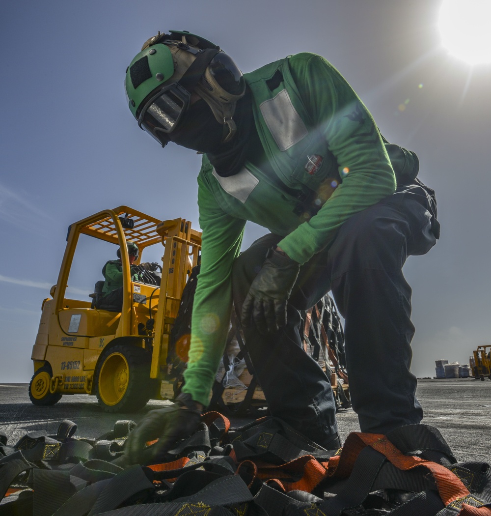 Logistics Specialist Collects Cargo Net During Vertical Replenishment-At-Sea On Flight Deck Aboard Aircraft Carrier USS Nimitz CVN 68