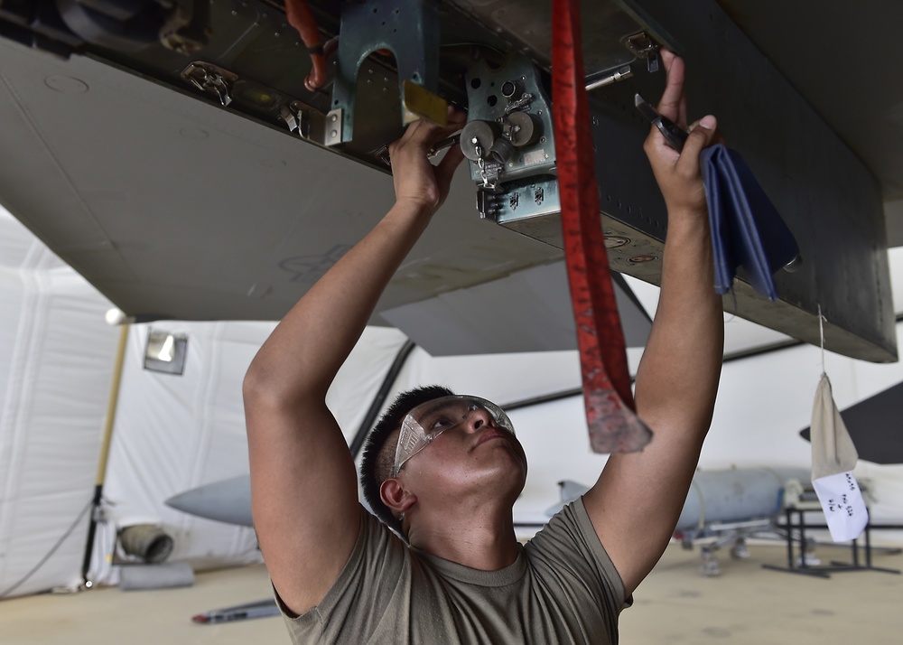 Weapons Airmen remove pylon for routine inspection