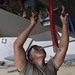 Weapons Airmen remove pylon for routine inspection