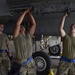 Weapons Airmen remove pylon for routine inspection