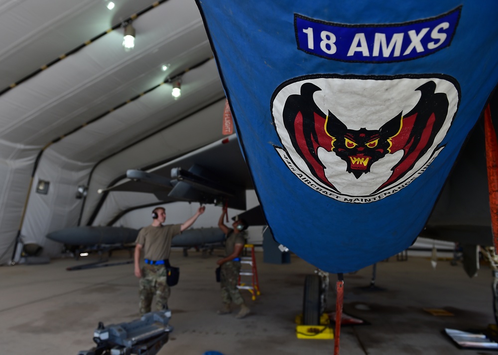 Weapons Airmen remove pylon for routine inspection