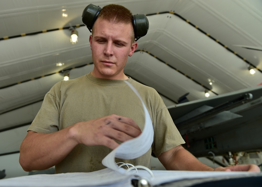 Weapons Airmen remove pylon for routine inspection