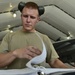 Weapons Airmen remove pylon for routine inspection