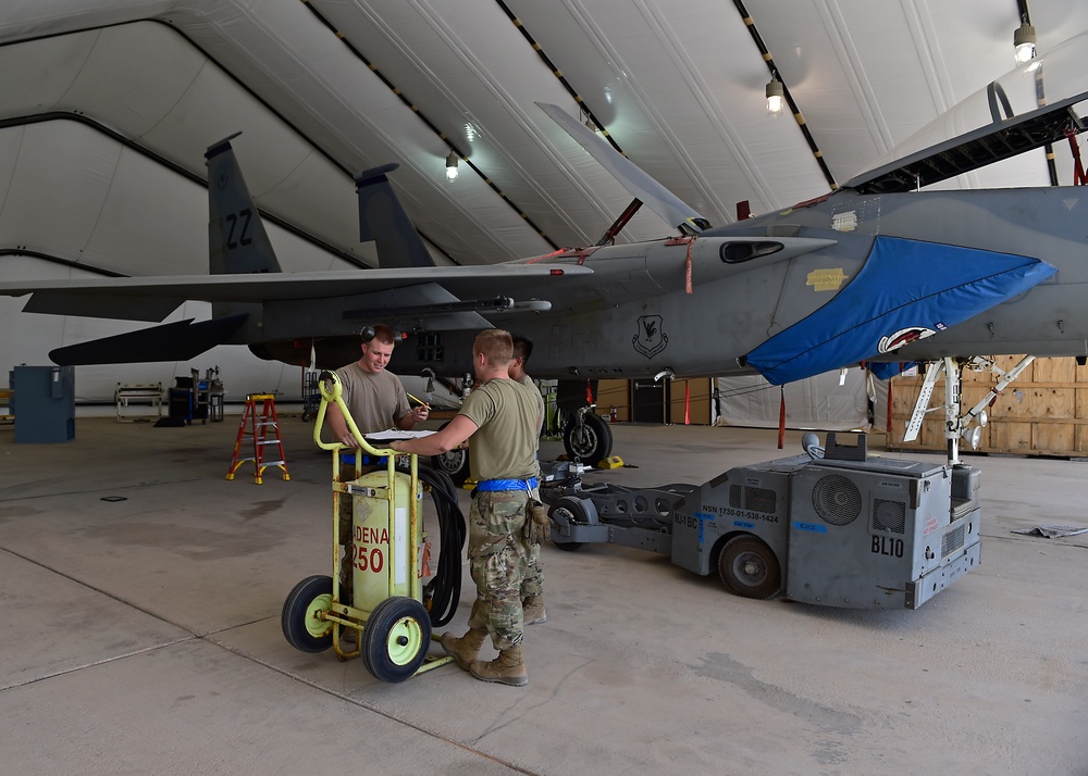 Weapons Airmen remove pylon for routine inspection