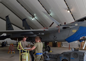 Weapons Airmen remove pylon for routine inspection