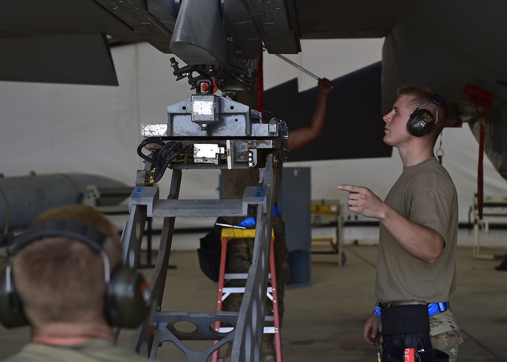 Weapons Airmen remove pylon for routine inspection