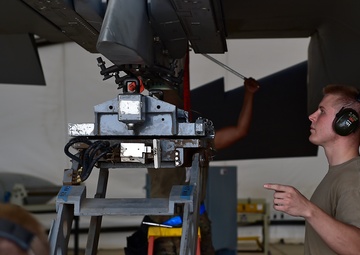 Weapons Airmen remove pylon for routine inspection