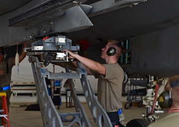 Weapons Airmen remove pylon for routine inspection