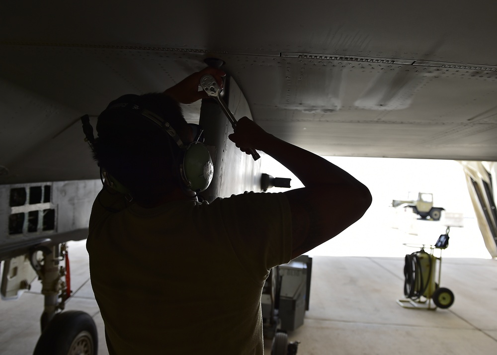 Weapons Airmen remove pylon for routine inspection