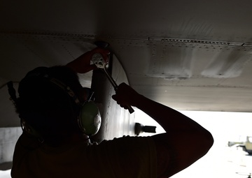 Weapons Airmen remove pylon for routine inspection