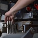 Weapons Airmen remove pylon for routine inspection