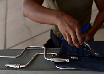 Weapons Airmen remove pylon for routine inspection