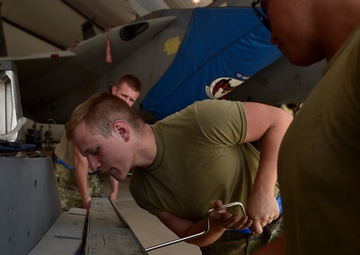 Weapons Airmen remove pylon for routine inspection