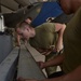 Weapons Airmen remove pylon for routine inspection