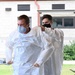 NMRTC-PH Sailors put on PPE prior to mass testing