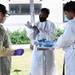 NMRTC-PH Expeditionary Testing Team puts on PPE prior to testing for COVID-19