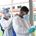 NMRTC-PH Expeditionary Testing Team puts on PPE prior to testing for COVID-19