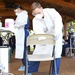 Sailor disinfects chair in COVID-19 testing site between patients