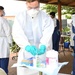 Sailor sanitizes gloves in COVID-19 testing site between patients
