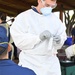 Hospital Corpsman prepares test swab prior to administering COVID-19 test