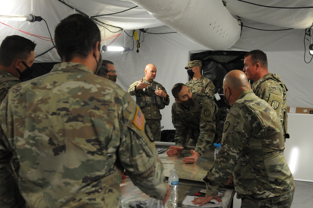 Col. Miner Reviews Plans on a Sand Table