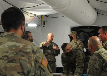 Col. Miner Reviews Plans on a Sand Table