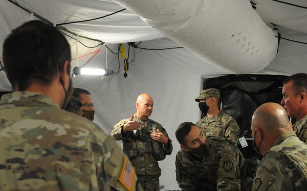 Col. Miner Reviews Plans on a Sand Table