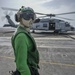 Aviation Structural Mechanic Oversees Airframer Troubleshooting On MH-60R Sea Hawk Helicopter, From The “Battlecats” of Helicopter Maritime Strike Squadron (HSM) 73, On Flight Deck Aboard Aircraft Carrier USS Nimitz CVN 68
