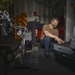 Sailor Troubleshoots Talon Explosive Ordnance Disposal (EOD) Robot In Hangar Bay Aboard Aircraft Carrier USS Nimitz CVN 68